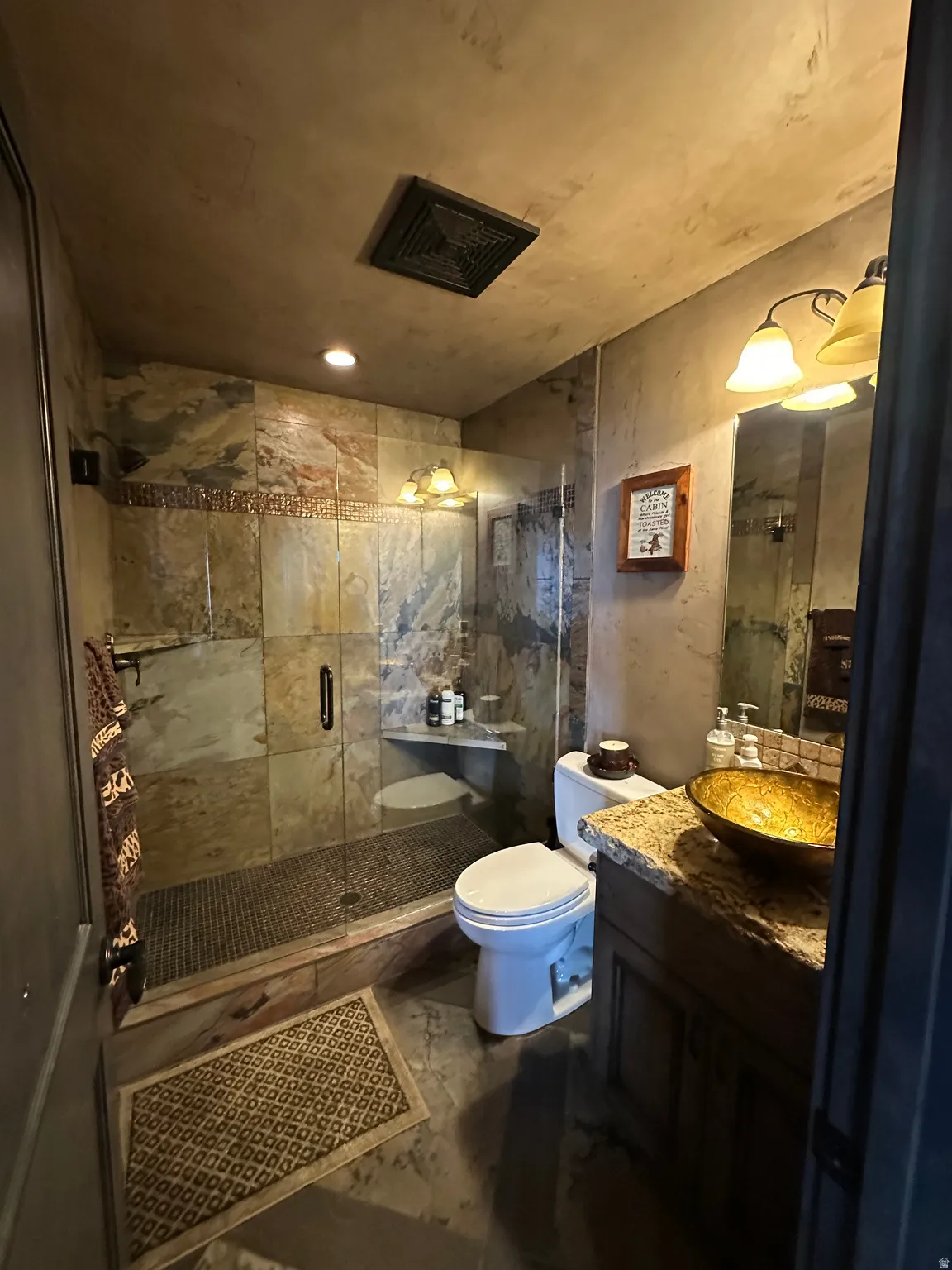 Bathroom featuring vanity and a shower and heated floors