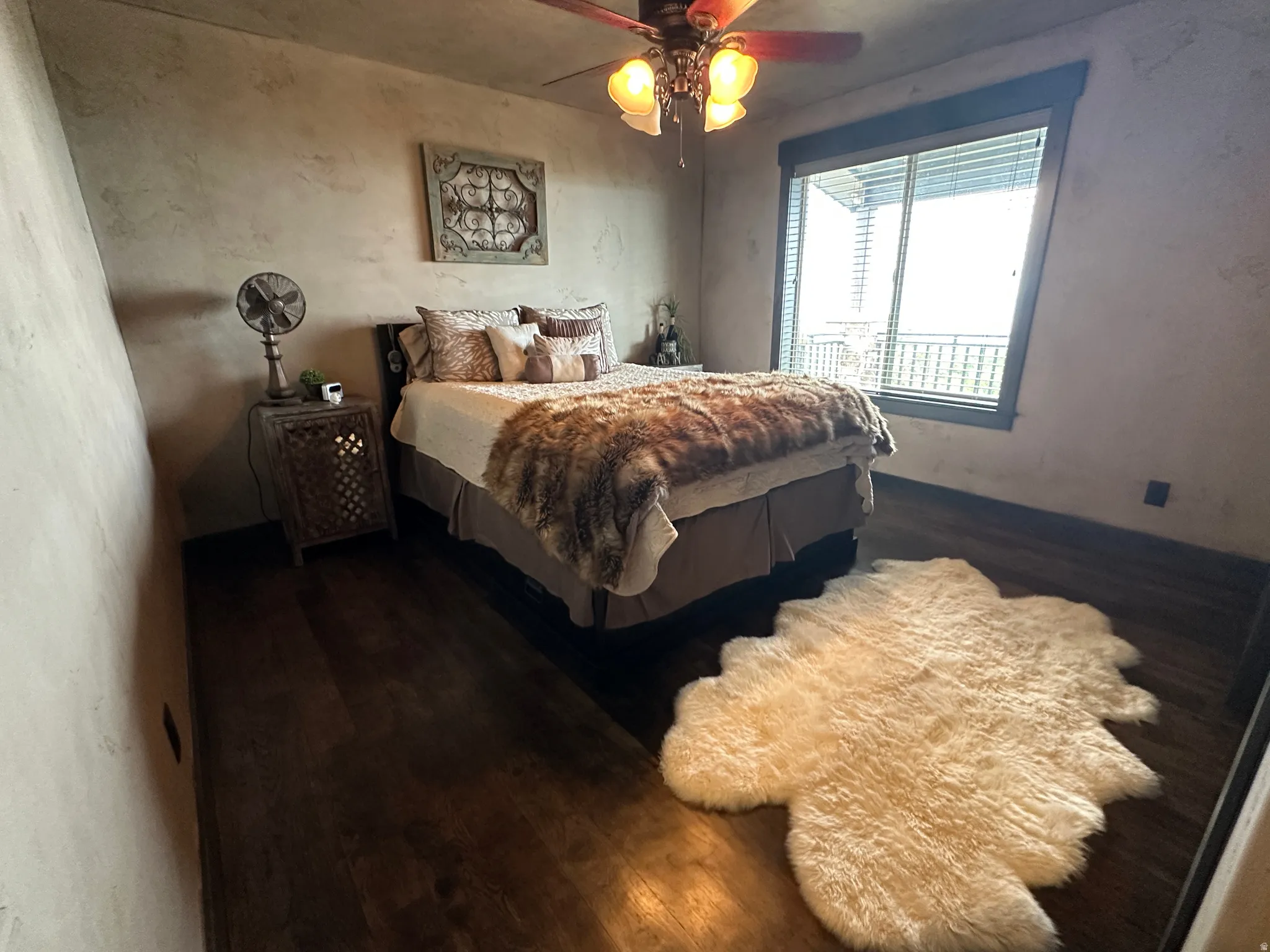 Bedroom featuring dark wood-style flooring and a ceiling fan