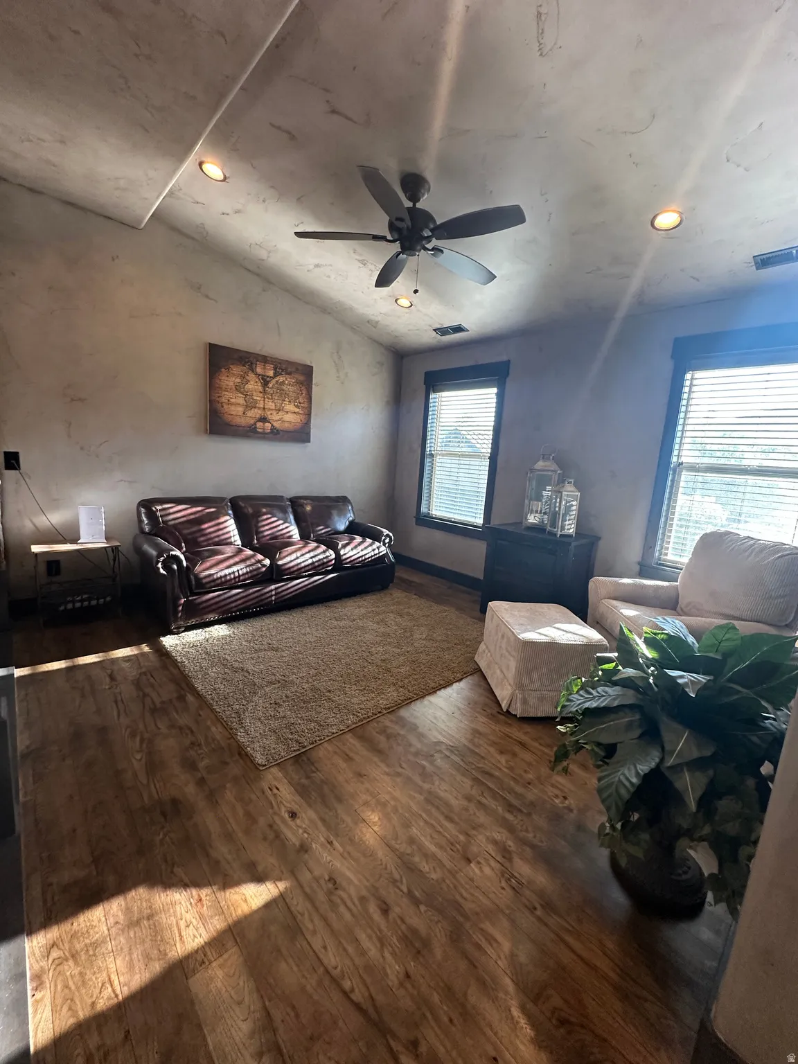 Loft living room with recessed lighting, hardwood / wood-style flooring, ceiling fan, and lofted ceiling