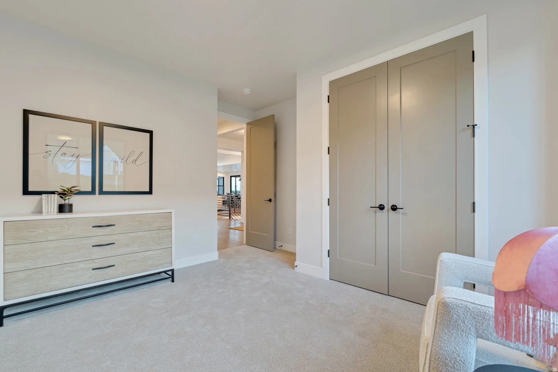 Bedroom featuring light carpet and a closet