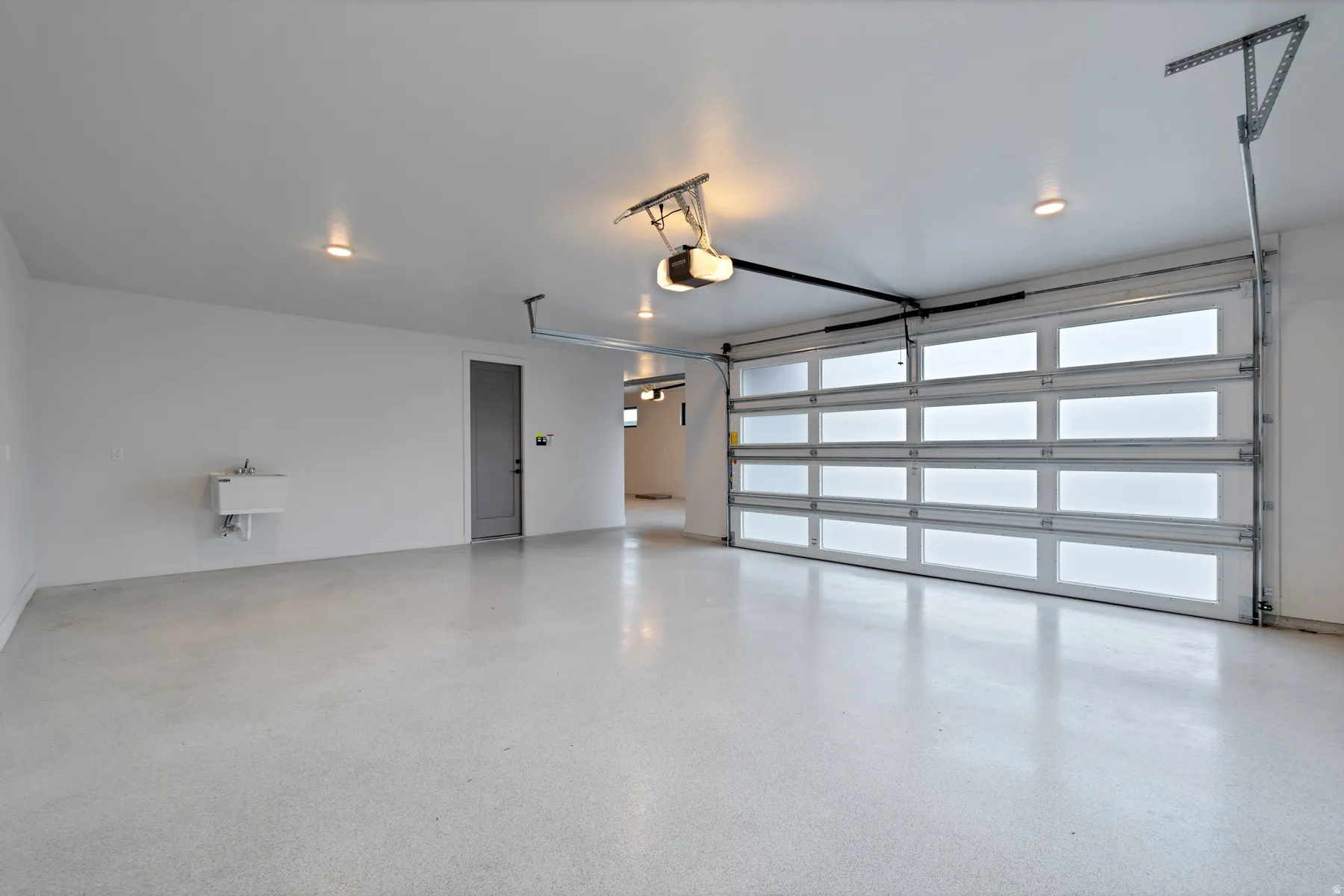 Garage with a sink and a garage door opener