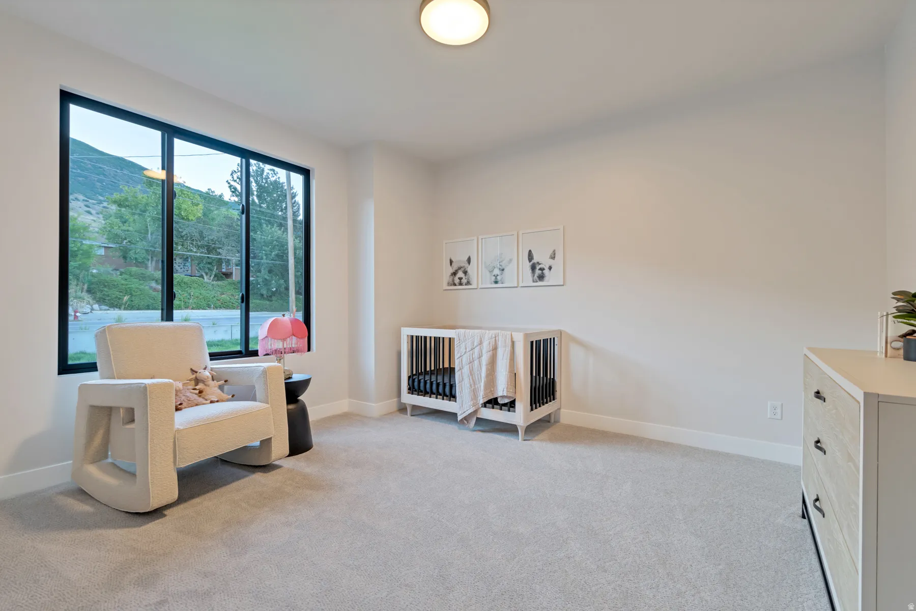 Living area featuring light colored carpet and a mountain view