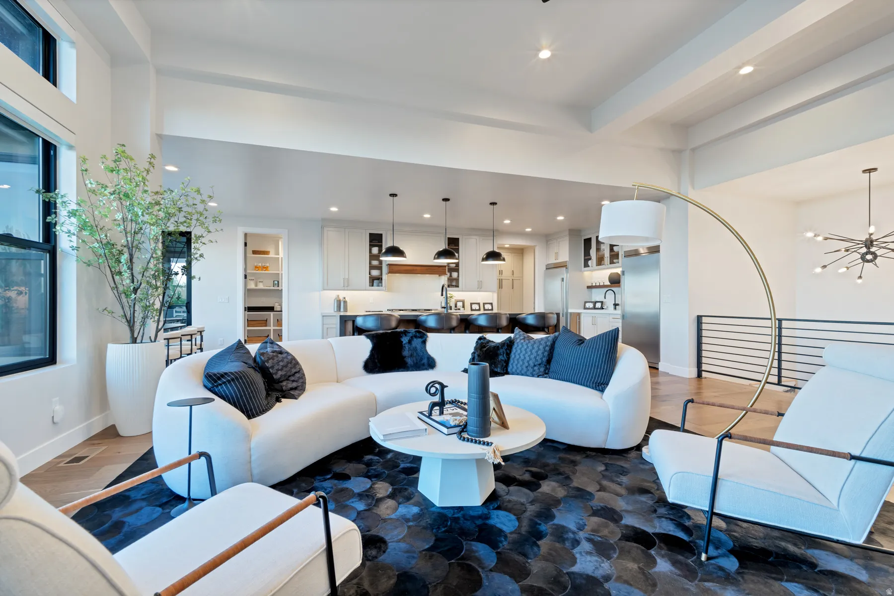 Living area featuring wood finished floors and suspended lighting