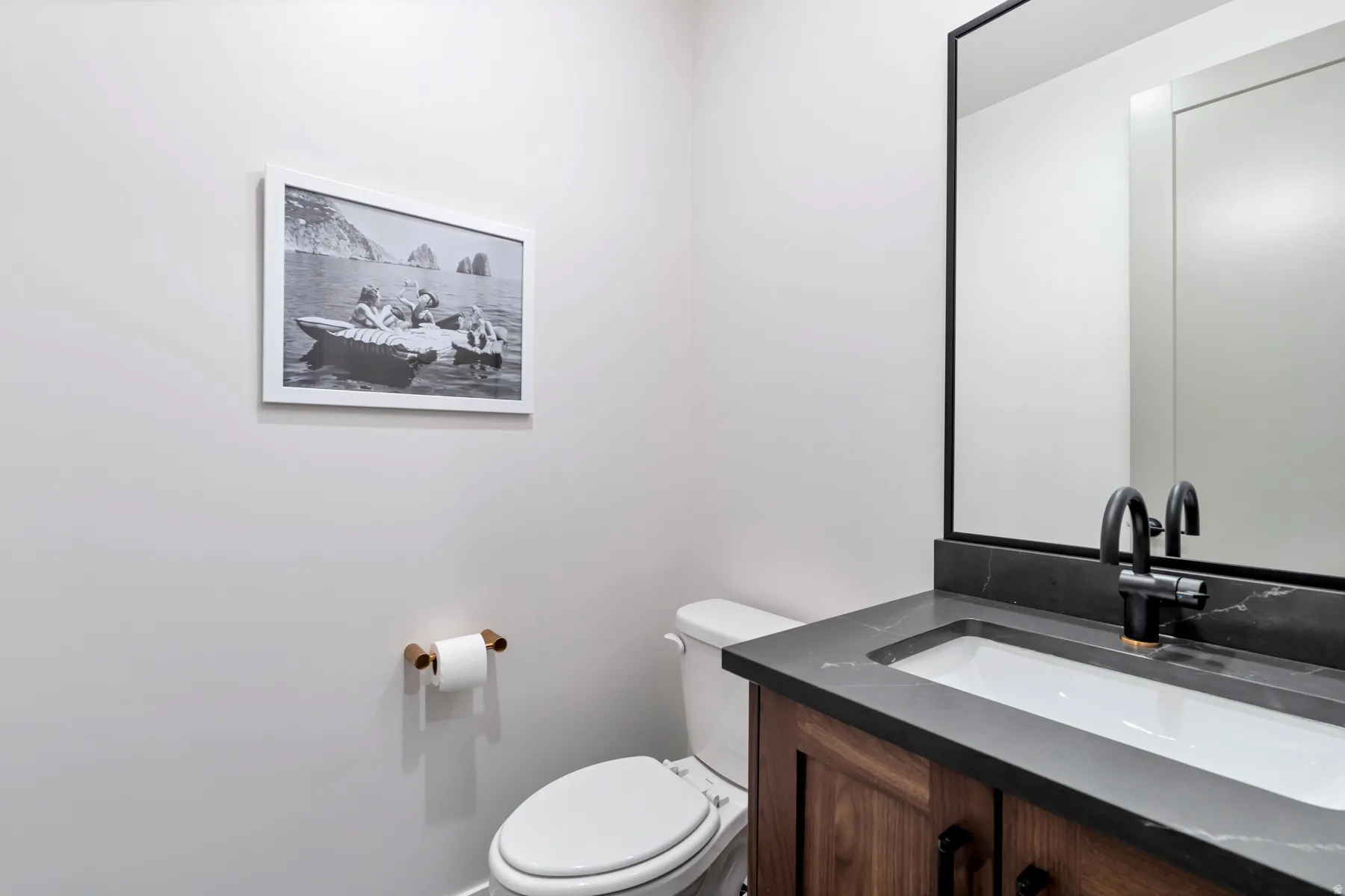 Half bathroom with vanity and toilet