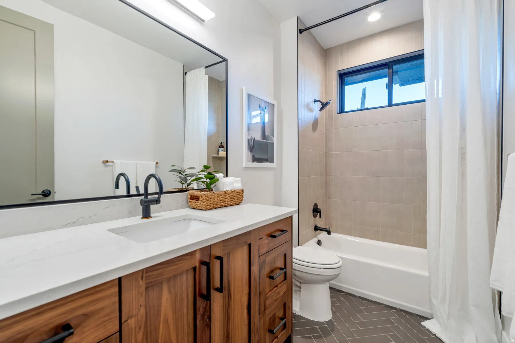 Bathroom featuring vanity and shower / tub combo with curtain