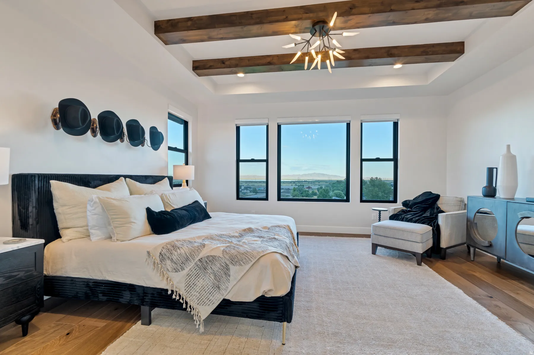 Bedroom with wood-type flooring, beam ceiling, and ceiling fan