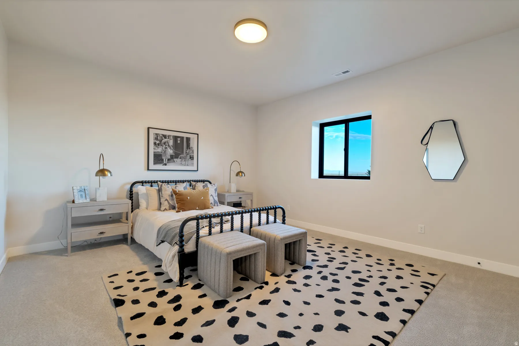 Bedroom with light colored carpet and baseboards