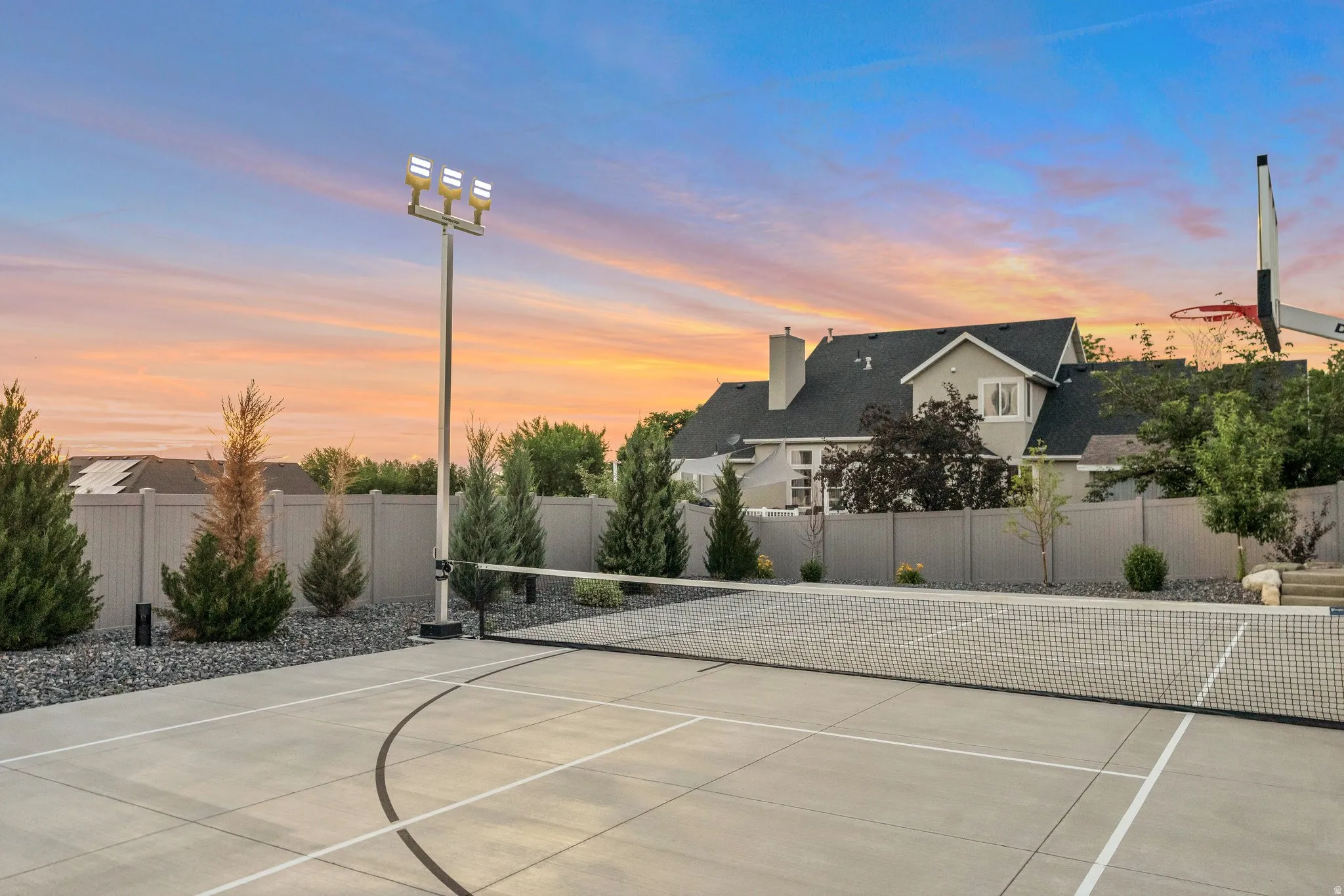 View of tennis court featuring a fenced backyard