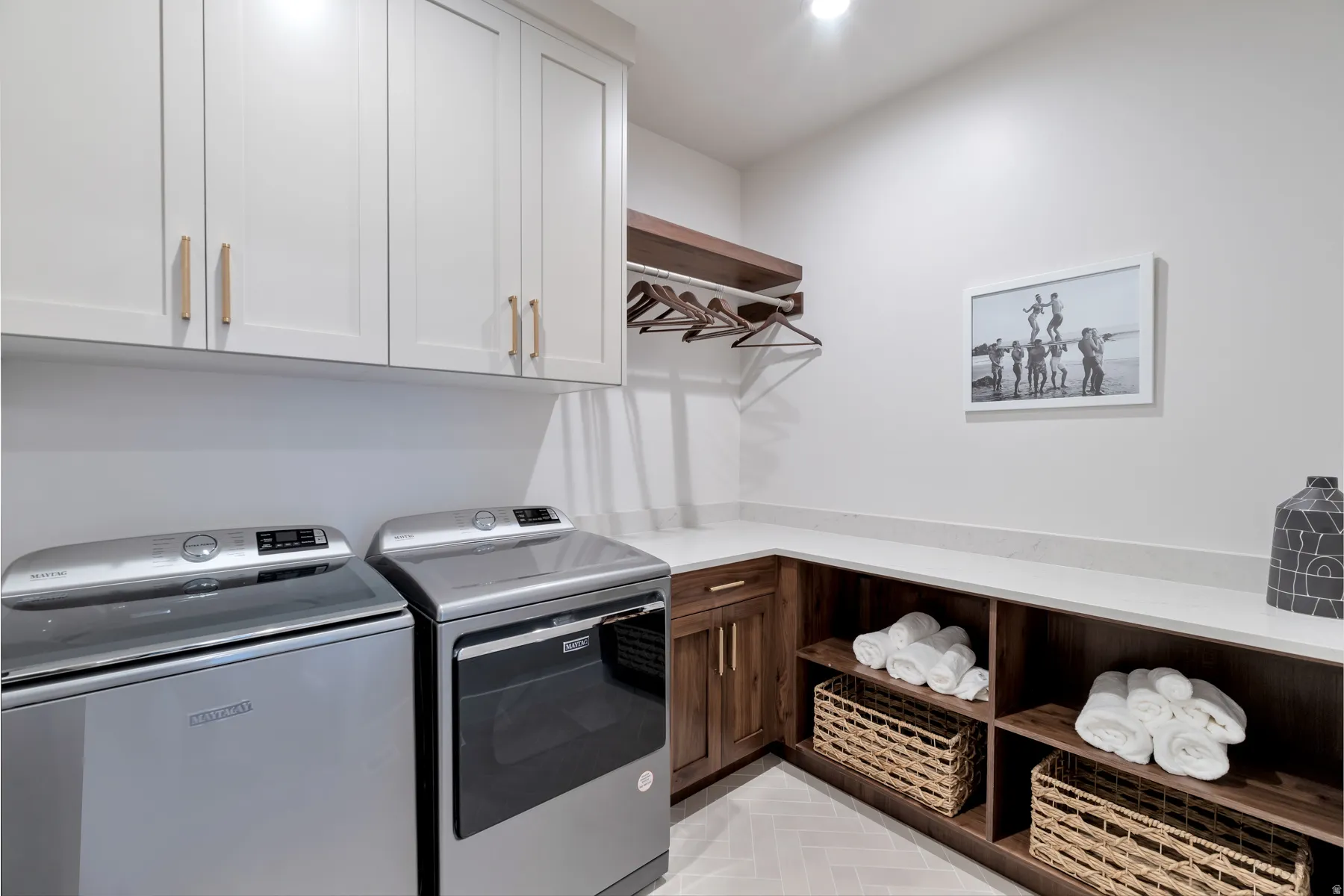 Laundry area featuring washing machine and dryer and cabinet space