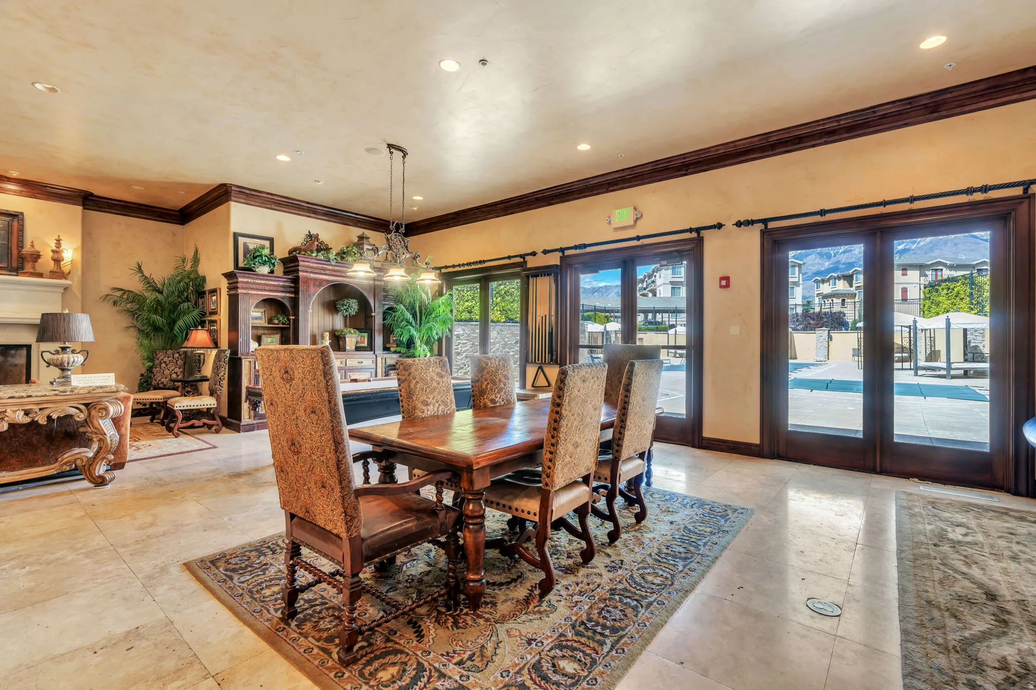 Dining space with a fireplace, crown molding, recessed lighting, and french doors