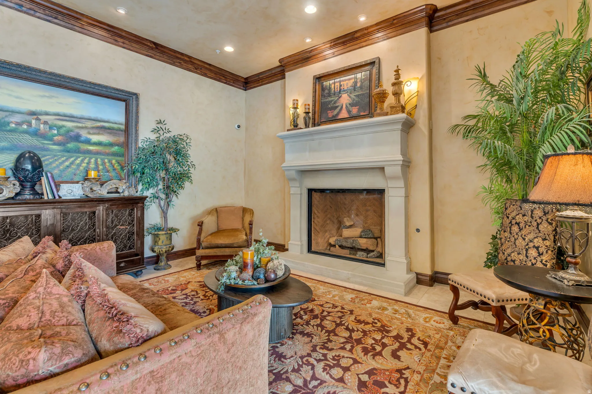 Tiled living area with a fireplace with raised hearth, recessed lighting, and crown molding
