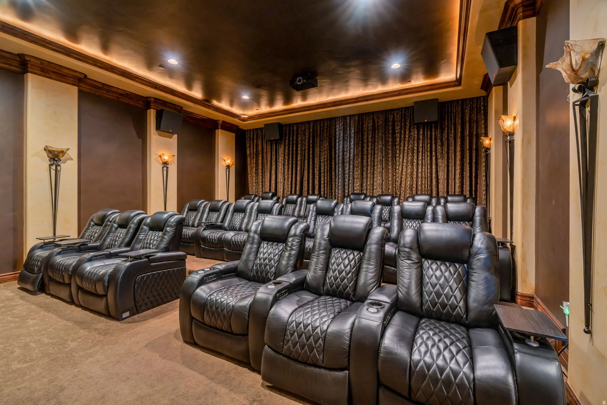 Carpeted home theater with a tray ceiling, crown molding, and recessed lighting