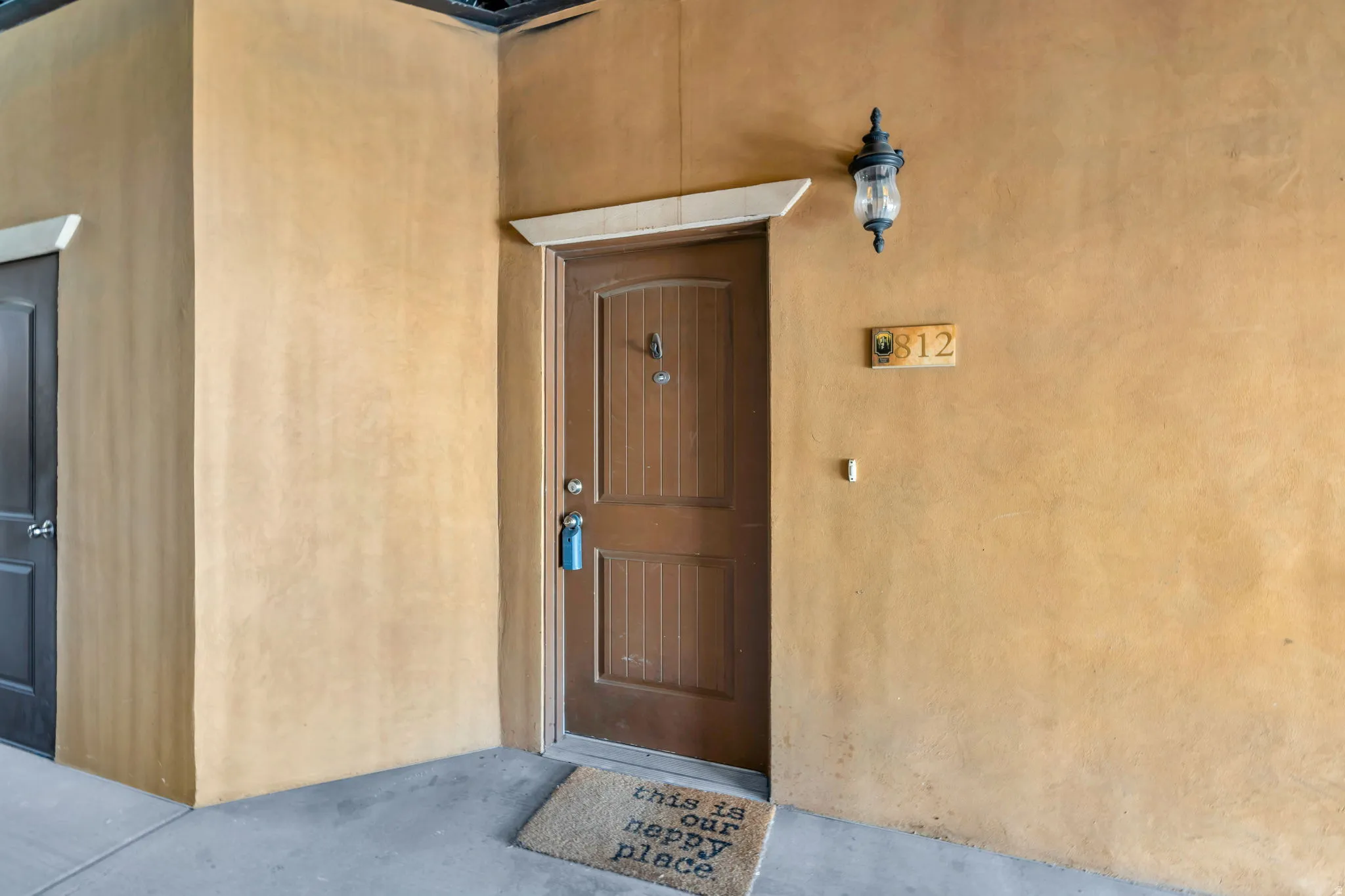 Entrance to property with stucco siding