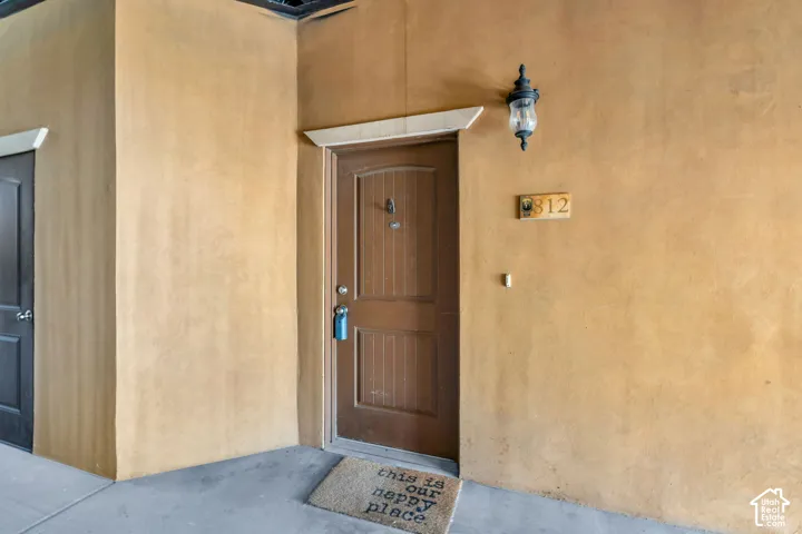 Entrance to property with stucco siding