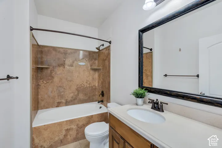 Bathroom with vanity and shower / washtub combination