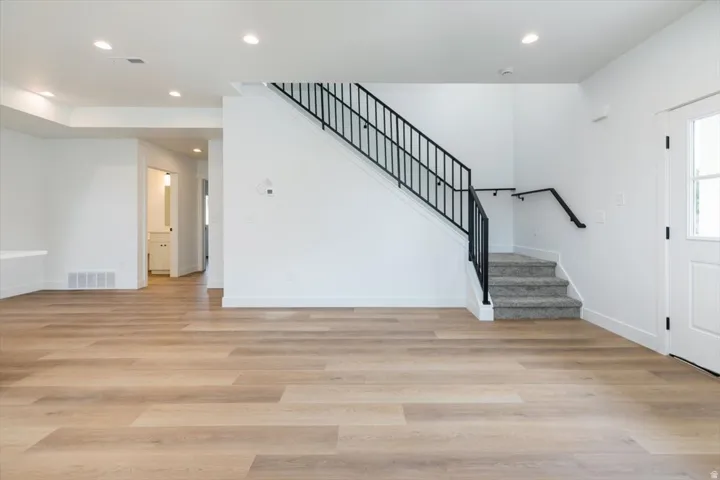 Foyer entrance featuring light wood finished floors and recessed lighting