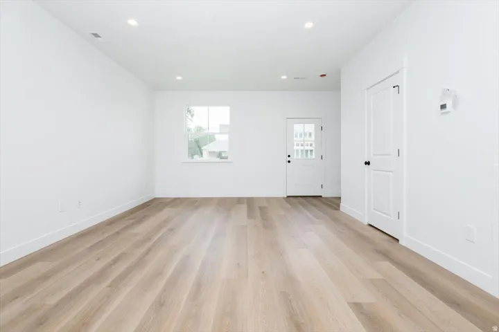 Spare room featuring light wood finished floors and recessed lighting