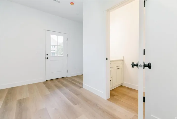 Entrance foyer featuring light wood-style flooring and baseboards