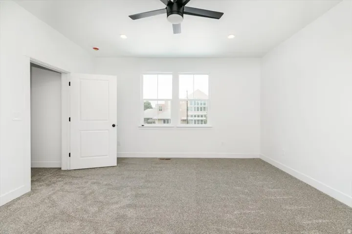 Unfurnished bedroom featuring carpet flooring, ceiling fan, and recessed lighting