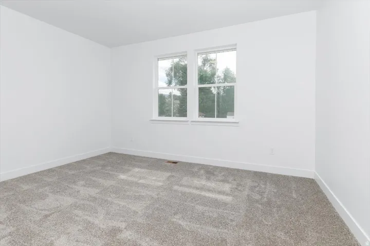 Unfurnished room featuring carpet floors and baseboards