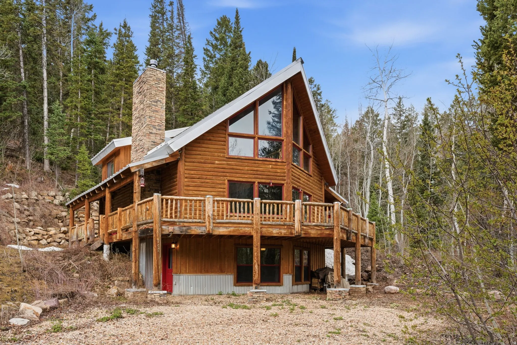 Back of house featuring a wooden deck and a chimney