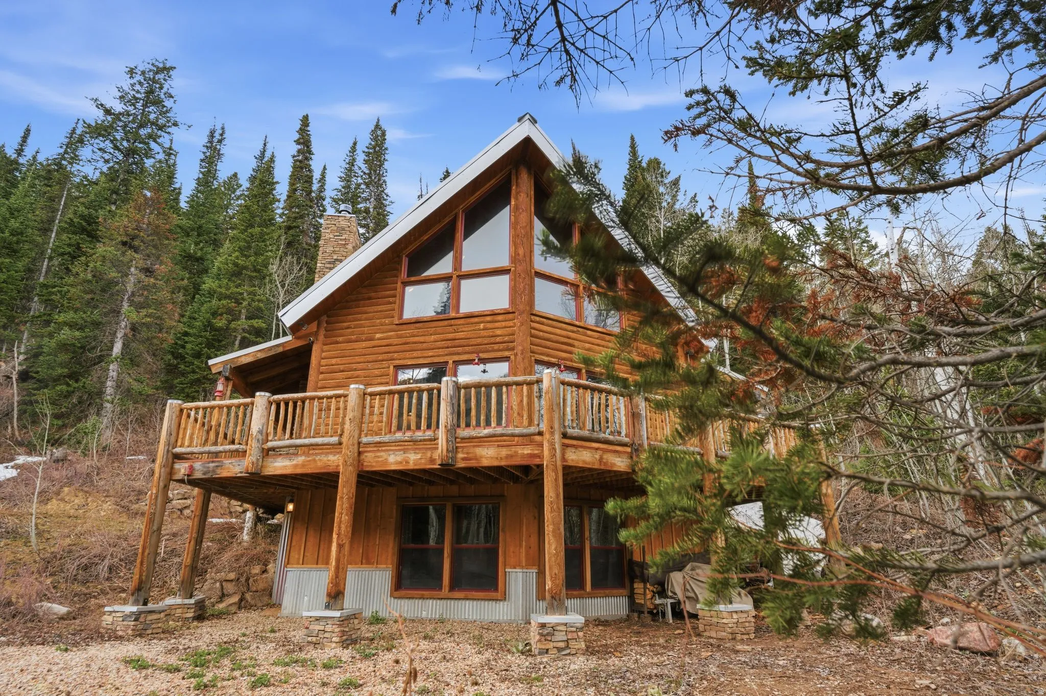 Back of house featuring a wooden deck and a chimney