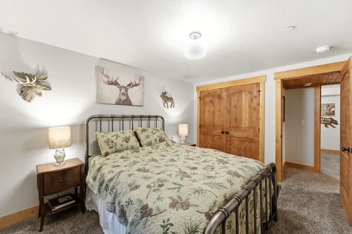 Carpeted bedroom with baseboards and a closet