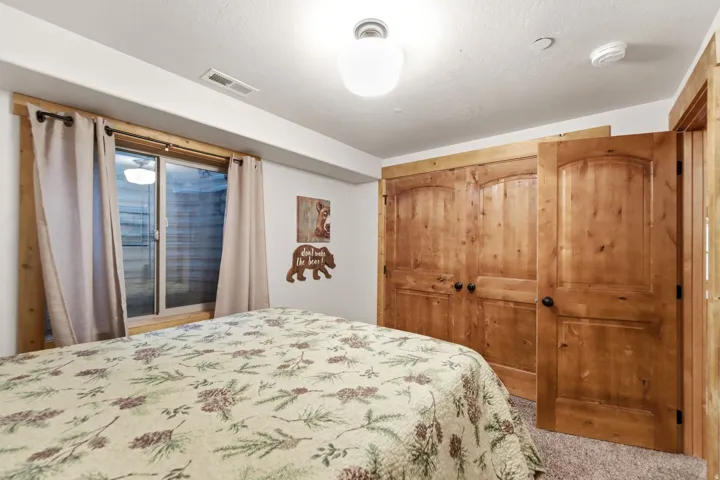 Bedroom with a closet, a textured ceiling, and carpet flooring