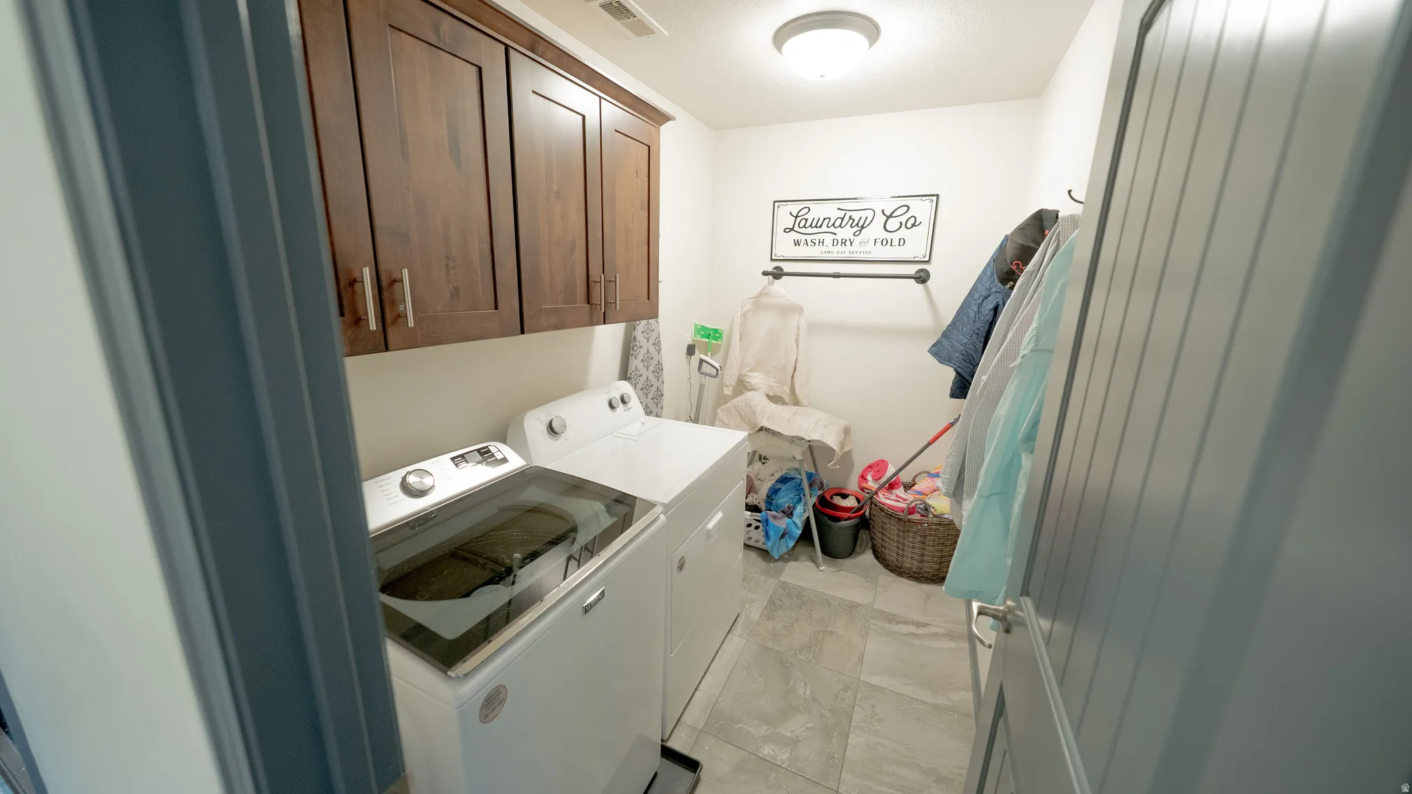 Laundry room featuring cabinet space and washing machine and dryer