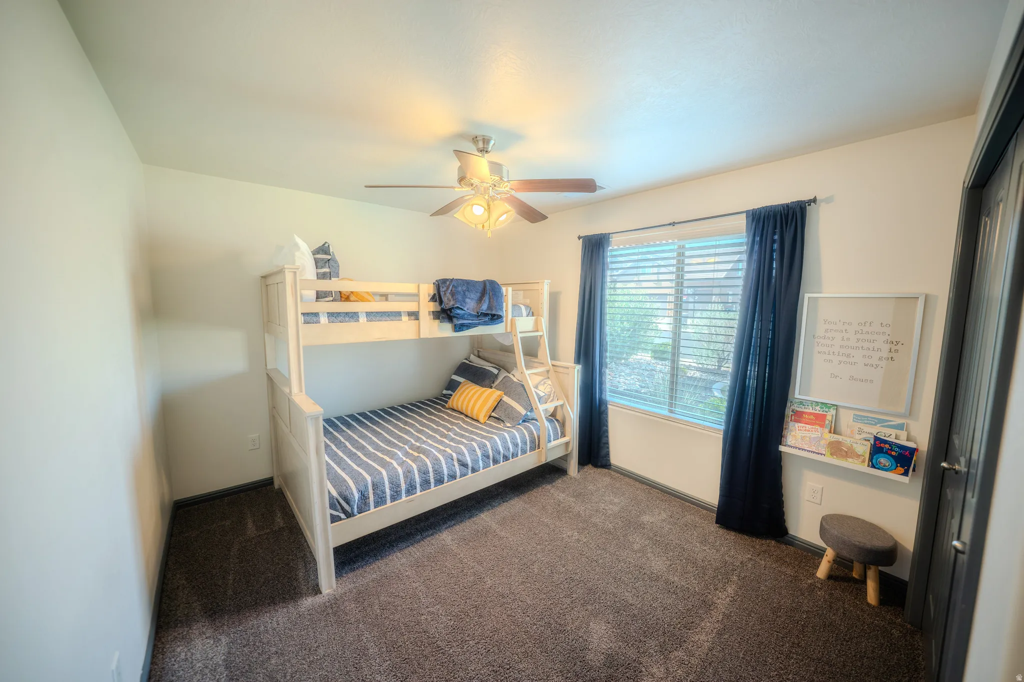 Bedroom with dark colored carpet and ceiling fan