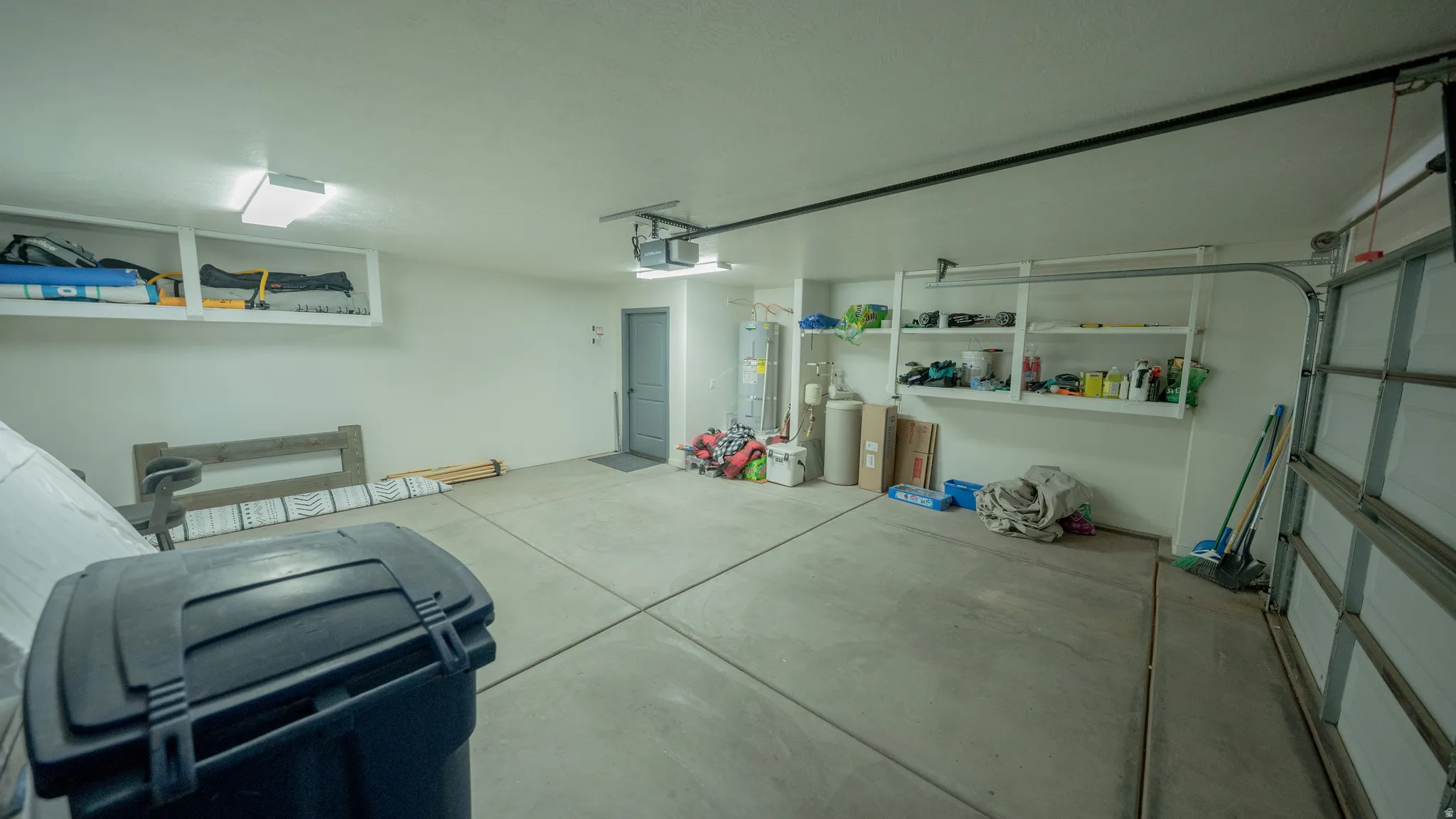Garage with water heater and a garage door opener