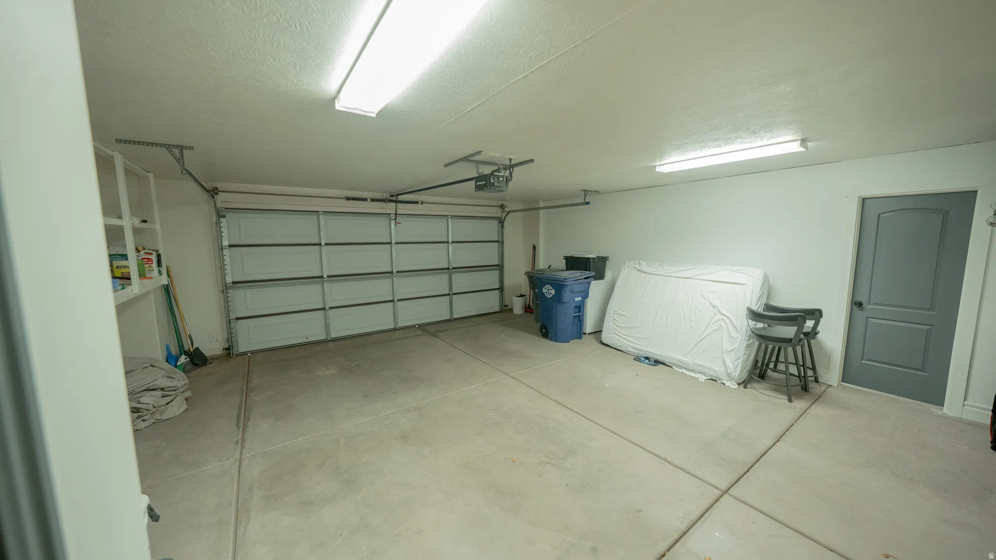 Garage featuring a garage door opener