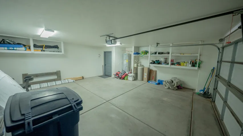 Garage with water heater and a garage door opener