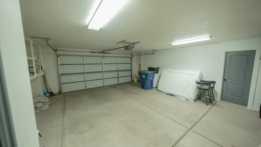 Garage featuring a garage door opener