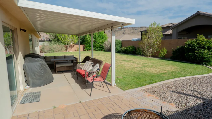 Fenced backyard featuring a patio, an outdoor lounge area, and area for grilling