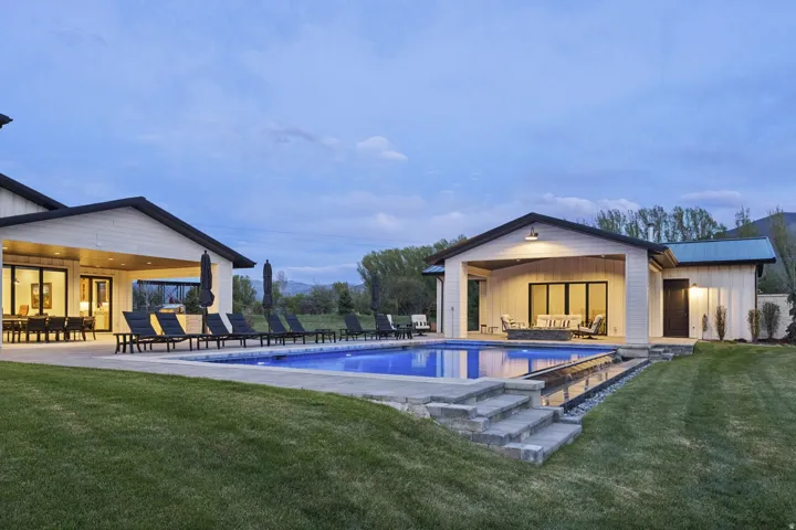Outdoor pool featuring a patio, outdoor lounge area, and a yard