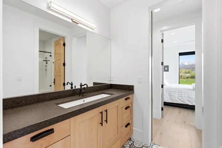Full bath featuring vanity, ensuite bath, light wood finished floors, and recessed lighting