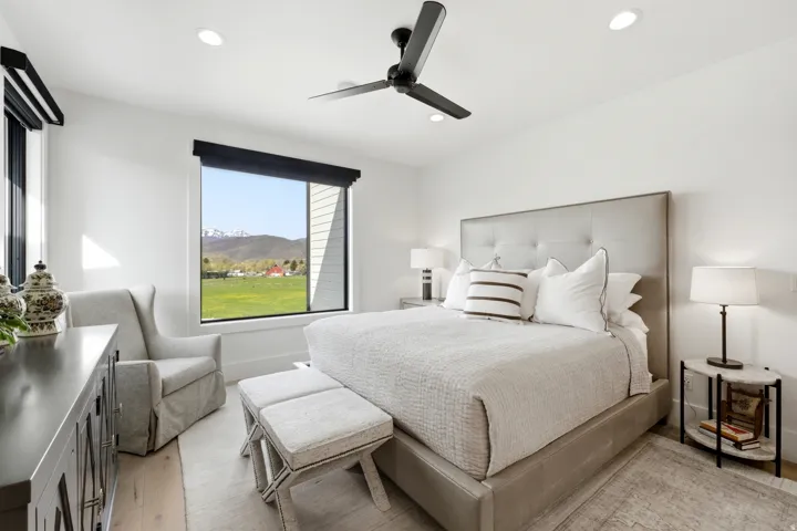Bedroom with a mountain view, ceiling fan, light wood finished floors, and recessed lighting