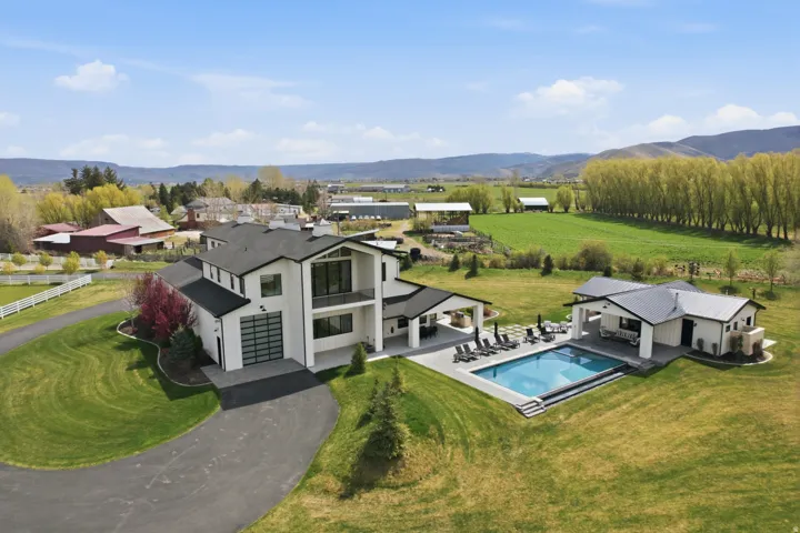 Overview of rural landscape featuring a pool area and a mountainous background