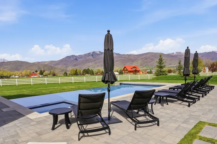 Fenced backyard with a mountain view and a patio area