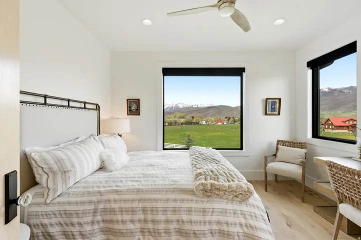 Bedroom featuring a mountain view, light wood-type flooring, a ceiling fan, and recessed lighting