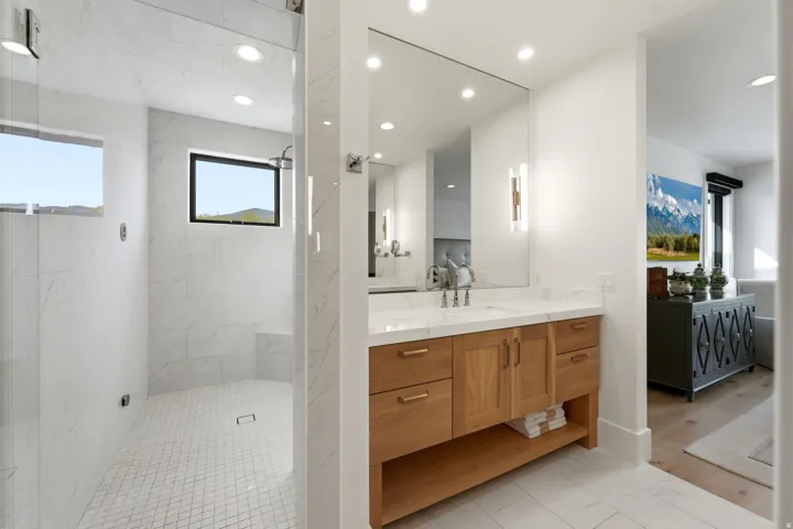 Bathroom with vanity, tiled shower, and recessed lighting