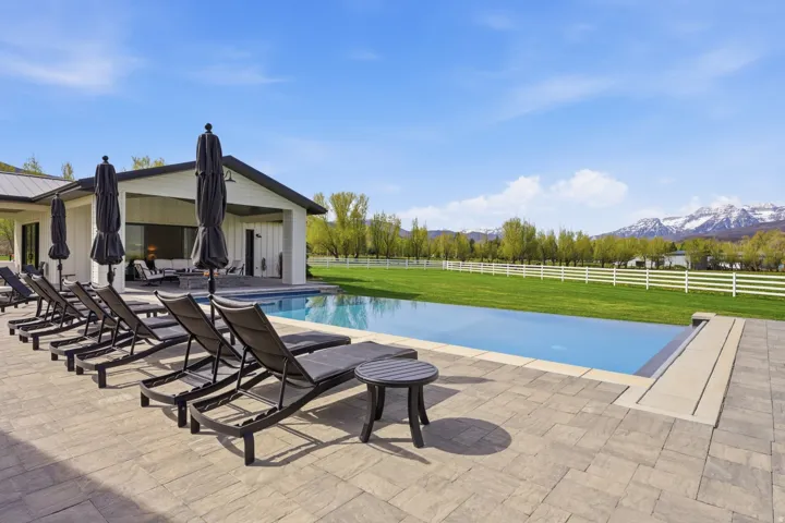 View of pool featuring patio surround and a mountain view