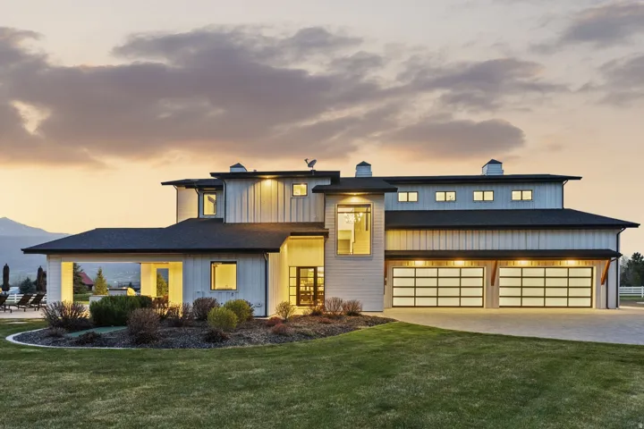View of front of house featuring a chimney, a yard, and driveway