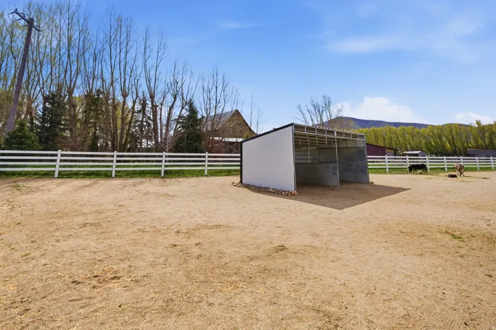 View of yard with an outbuilding, a view of rural / pastoral area, and an exterior structure