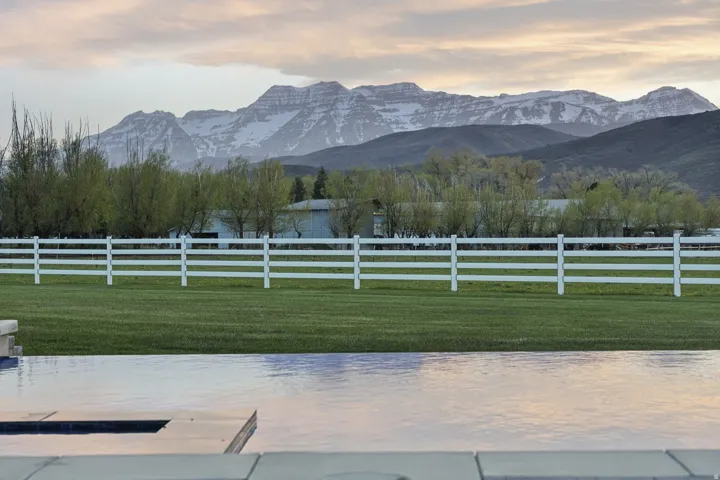 View of mountain backdrop featuring rural landscape and agricultural land