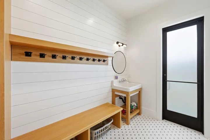 Mudroom with wood walls and a sink