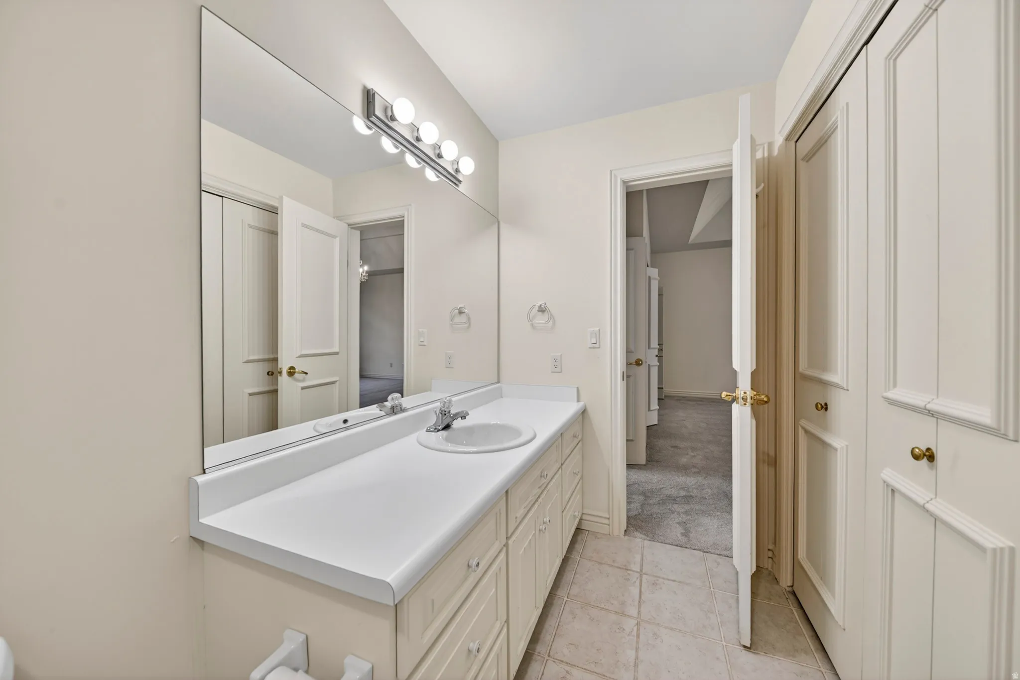Bathroom featuring vanity and light tile floors