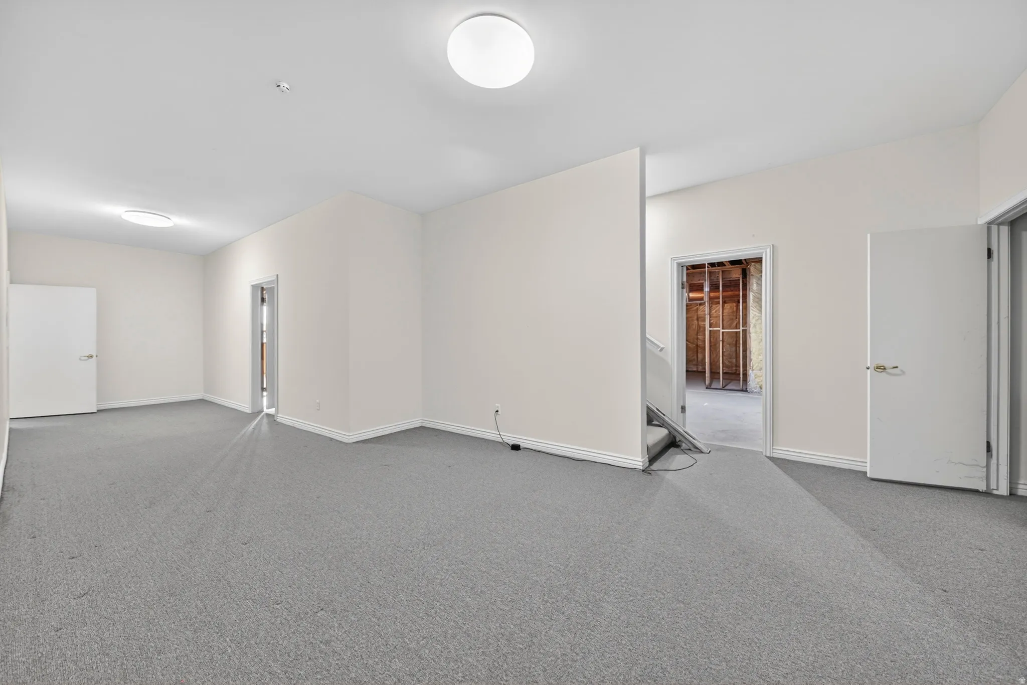 Unfurnished room featuring carpet floors and baseboards