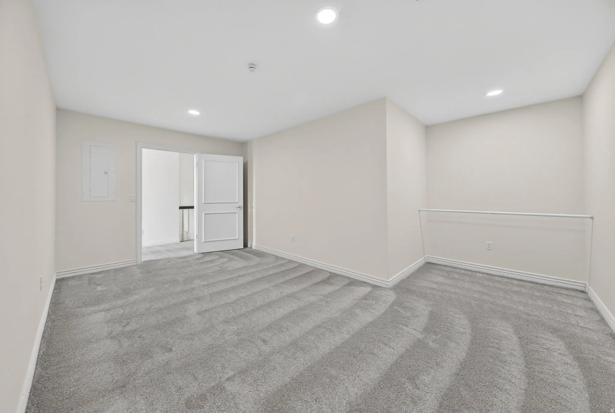 Bonus room featuring recessed lighting, light colored carpet, and electric panel